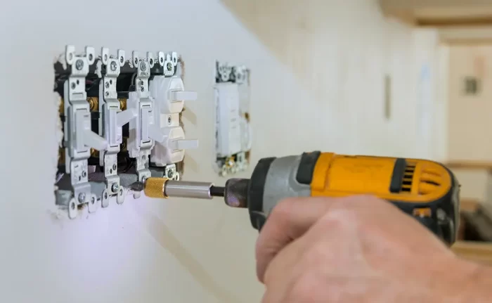Electrical Switches Being Installed with a Drill