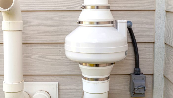 Radon Mitigation System mounted on the side of a home