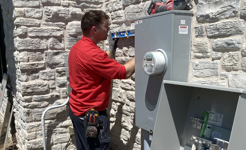 Electrician Connecting Wiring While Installing a Generator