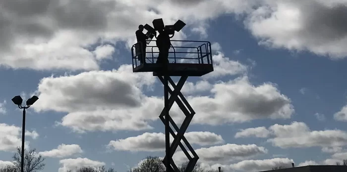 Two Men Working on a Parking Lot Light